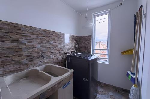a bathroom with a sink and a brick wall at amplio y lujoso apartasuite en el centro in Cartago