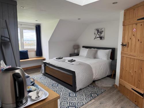a bedroom with a bed and a tv in a room at Islecroft House Bed & Breakfast in Isle of Whithorn