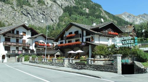 a hotel on a road in front of a mountain at Hotel Del Viale in Courmayeur