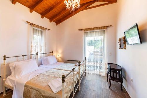 a bedroom with a bed and a large window at Villa Loulou by Villa Plus in Nikiana