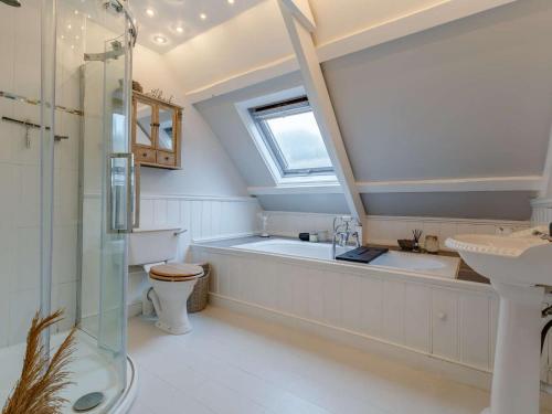 a bathroom with a shower and a tub and a sink at 2 Bed in Penzance oc-85610 in St. Just