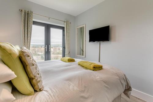 a bedroom with a bed with two yellow pillows on it at 3 Bed in Croyde oc-hector in Croyde