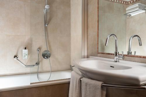 a bathroom with a sink and a shower at Hotel Athena in Siena