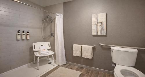 a bathroom with a toilet and a shower at Best Western PLUS Peppertree Airport Inn in Spokane