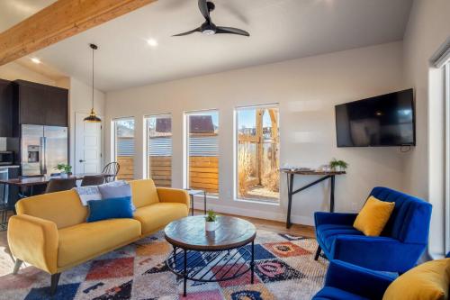 a living room with two couches and a table at Timber & Tin B 1Bed 1Bath w Pool & Rooftop Deck in Kanab