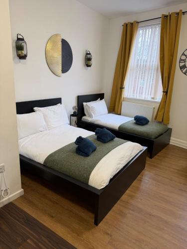 two beds in a bedroom with towels on them at City-Centre Studio · Self-Contained · Sleeps 3 in Nottingham
