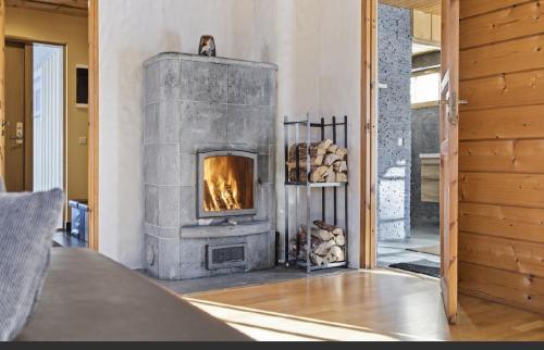 a fireplace in the living room of a house at Kasekuma House with all comforts well located in Otepää