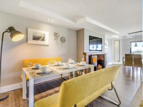 a dining room with a table and a yellow chair at Keppel Gate in Heriot
