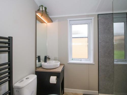 a bathroom with a sink and a window at Poppy in Leominster