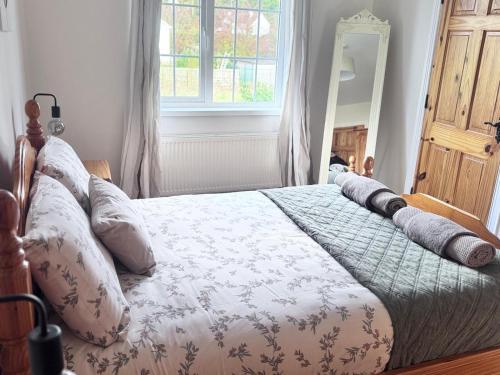 a bedroom with a bed with pillows on it at Clones Town House in Cluain Eois