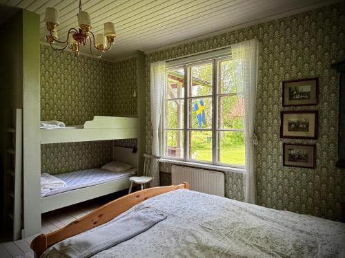 a bedroom with a bed and a window at Lägenhet Strömsberg F in Strömsberg