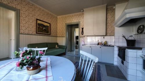 a kitchen and living room with a table and a couch at Lägenhet Strömsberg F in Strömsberg