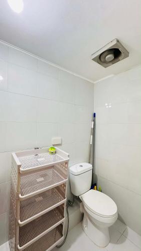 a white bathroom with a toilet and a ceiling at ONE SPATIAL 2Bedrooms Apartment Flat LLD Iloilo City Philippines in Iloilo City
