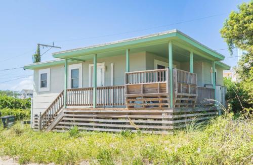 a house with a large porch with a large deck at Bennett's Bungalow - S Nags Head MP 17, 30 Yds to Beach, Year Round Flex Stays in Whalebone