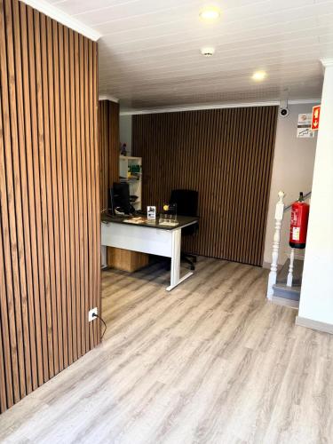 an office with a desk and a computer in a room at Residencial Melba in Funchal