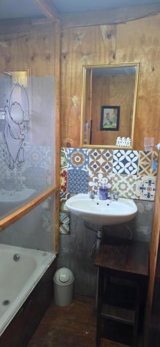 a bathroom with a sink and a bath tub at Buffelslaagte at the Vaal in Oranjeville