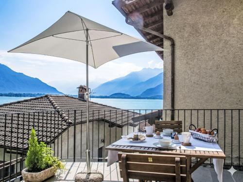 a patio with a table and an umbrella at Apartment Titti - GLA133 by Interhome in Gera Lario