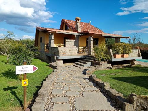 a house with a sign in front of it at Chalet Melograno by Interhome in Sutri