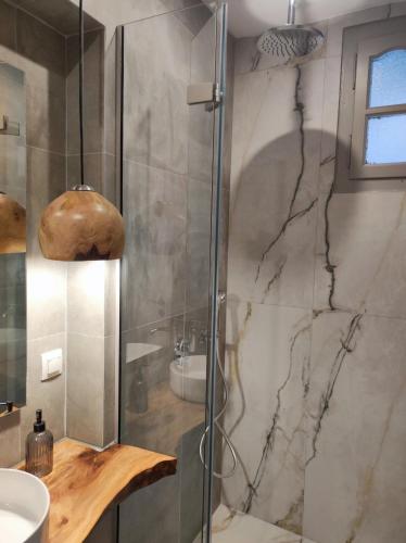 a bathroom with a shower and a sink at Reborn Project Acropolis in Skiathos