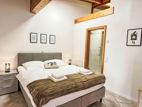 a bedroom with a large bed with two towels on it at Apartment Feingeist by Interhome in Löffingen