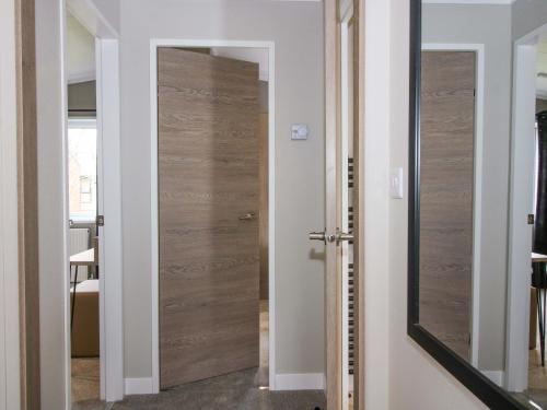 a sliding door in a room with a mirror at Tulip in Leominster