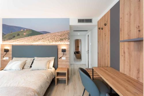 a bedroom with a bed and a wooden table at Relais del Borgo in Lentiai