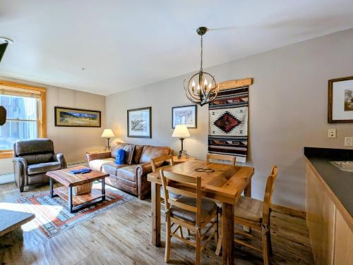 a living room with a table and a couch at Buffalo Lodge 8320 by SummitCove Lodging in Keystone