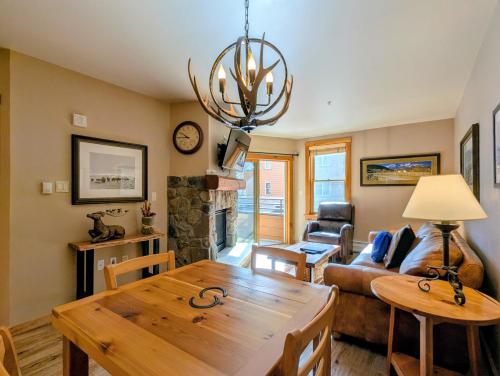 a living room with a table and a couch at Buffalo Lodge 8320 by SummitCove Lodging in Keystone