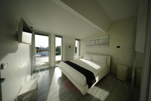 a bedroom with a large bed and a balcony at Eden Luxury Villa in Focene