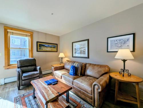 a living room with a couch and a table at Buffalo Lodge 8320 by SummitCove Lodging in Keystone