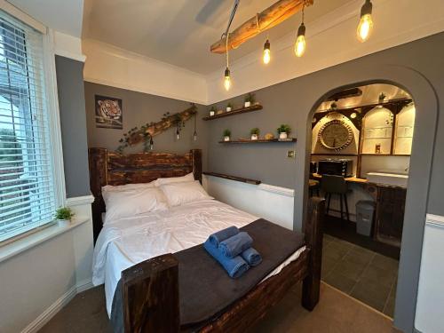a bedroom with a bed and a bathroom with a sink at Marton Lodge in Bridlington