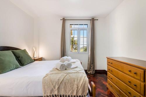 a bedroom with a bed and a dresser and a window at Villa Santana by GALMI in Santana