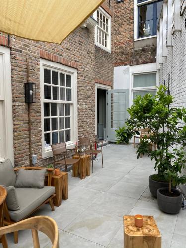 an outdoor patio with tables and chairs at HARBOR HOUSE ZEELAND - nl in Goes