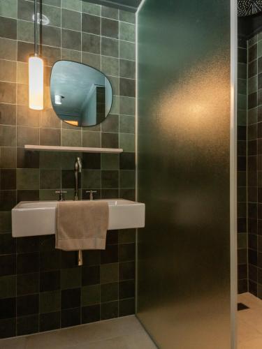 a bathroom with a sink and a mirror at HARBOR HOUSE ZEELAND - nl in Goes