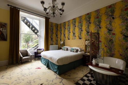 a bedroom with a bed and a tub in a room at 24 Royal Terrace in Edinburgh