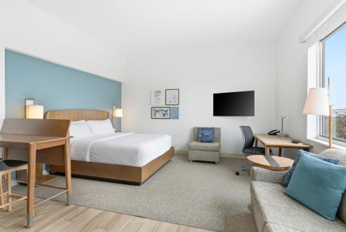 a hotel room with a bed and a desk at Element by Marriott Houston Katy in Katy