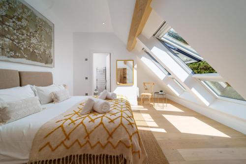 a bedroom with a bed in a room with skylights at Tors Park in Lynmouth