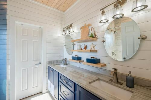 a bathroom with a sink and a mirror at Horizon House Stay. Relax. Repeat. in Port Aransas