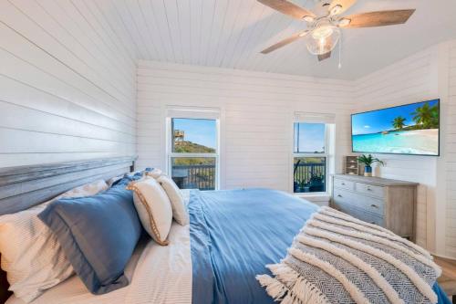 a bedroom with a bed and a ceiling fan at Horizon House Stay. Relax. Repeat. in Port Aransas