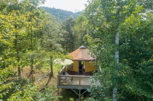 a tree house in the middle of a forest at Summerset Ridge in Cullowhee