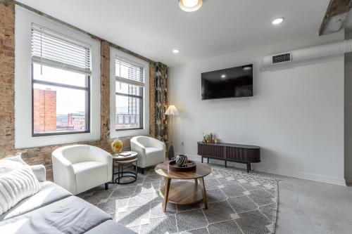 a living room with a couch and a table at Park Hotel 2BR Suite 406 in Chattanooga