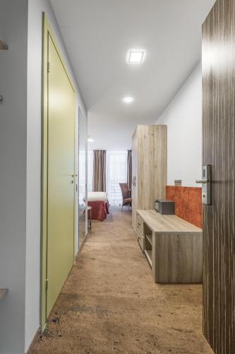 a hallway of an office with a door and a table at HOF Apartments in Kaunas