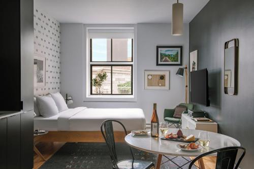 a living room with a white couch and a table at The Alexander - Old Montreal in Montreal