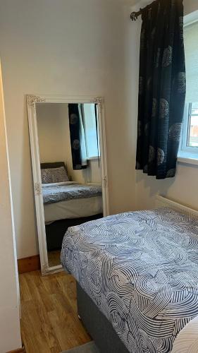 a bedroom with a mirror and a bed in it at 83 Clonmullion Athy county Kildare in Athy