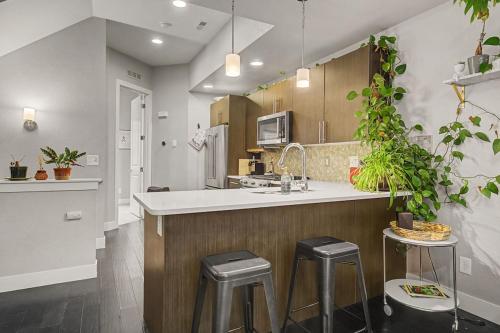 a kitchen with a counter and stools in a room at Spacious Denver Home with Private Rooftop Spa in Denver