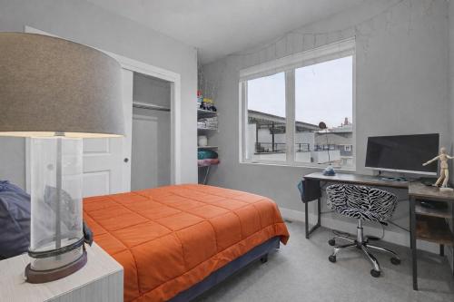 a bedroom with a bed and a desk and a window at Spacious Denver Home with Private Rooftop Spa in Denver