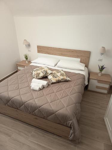 a bedroom with a large bed with towels on it at B&B Santa Filomena in Laterza
