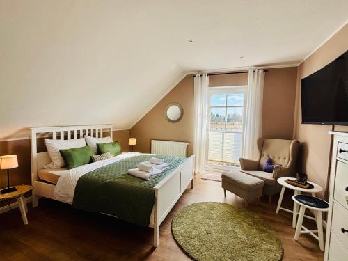 a bedroom with a large bed and a window at Ferienzimmer Claudia in Surwold