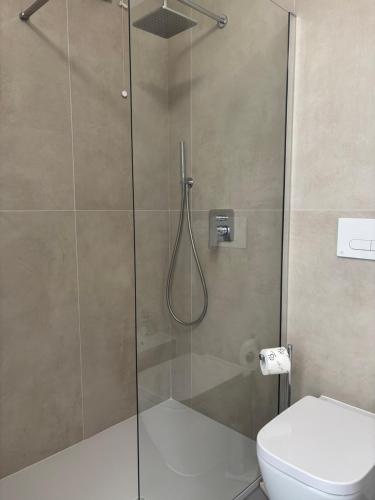 a bathroom with a glass shower with a toilet at Giorgia's House in Silvi Marina