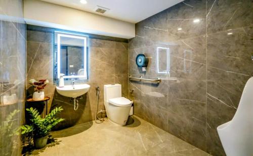 a bathroom with a toilet and a sink at Bangkok Esque Sukhumvit101 Condo NEW Building in Amphoe Phra Khanong